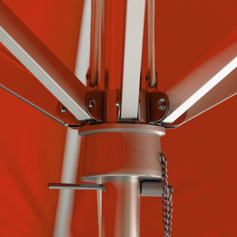 Close-up of BAJAMATE umbrella hub showing heavy-duty aluminum ribs bolted into a reinforced central housing on a 2-inch pole