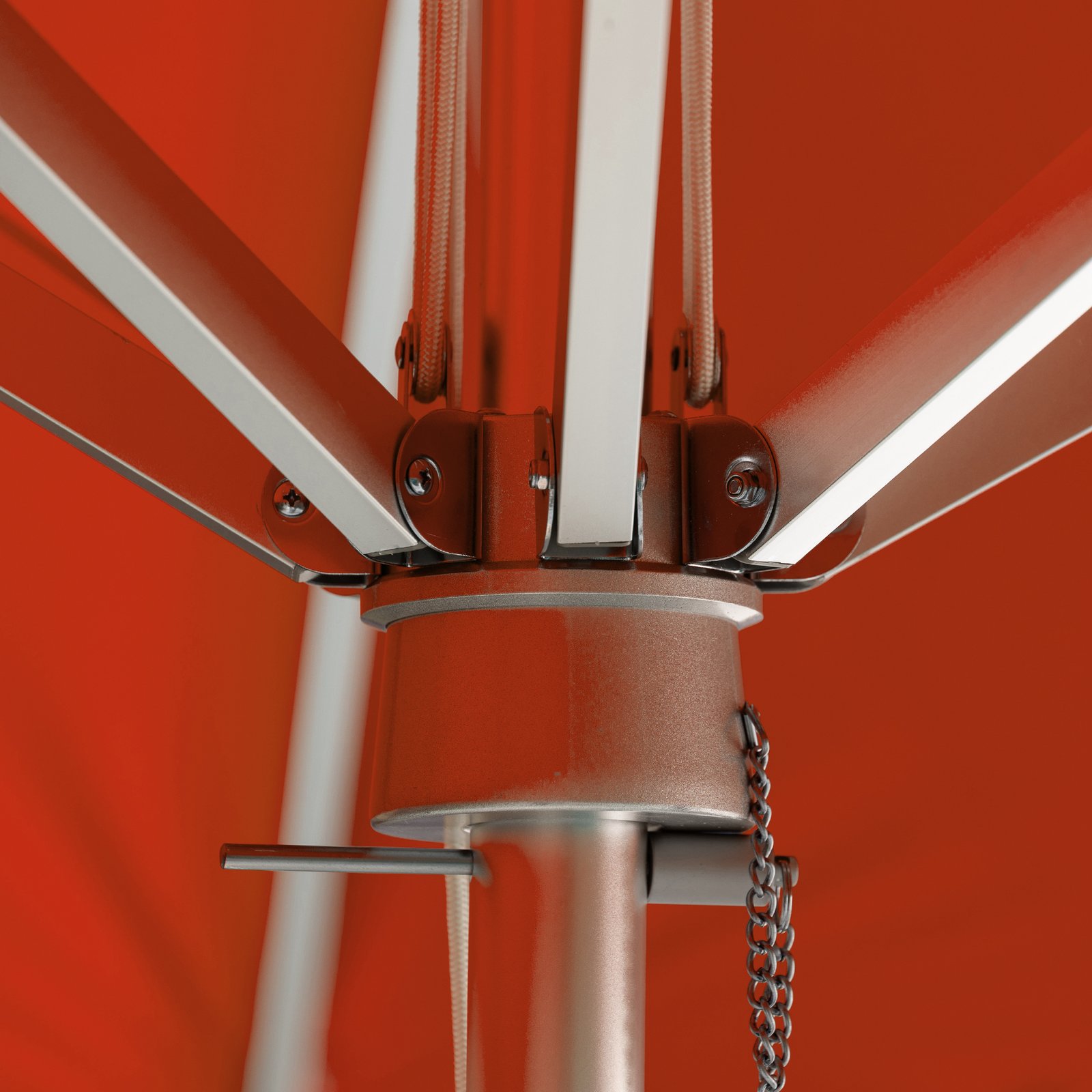 Close-up of BAJAMATE umbrella hub showing heavy-duty aluminum ribs bolted into a reinforced central housing on a 2-inch pole