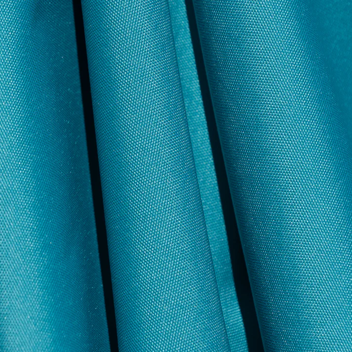 Close-up of a BajaMate Umbrella with a 2" silver aluminum pole and UV-resistant fabric in vibrant blue, showcasing its heavy-duty stainless steel crank mechanism and integrated 20-watt solar panel with a micro USB charging port for poolside use. The Teal umbrella