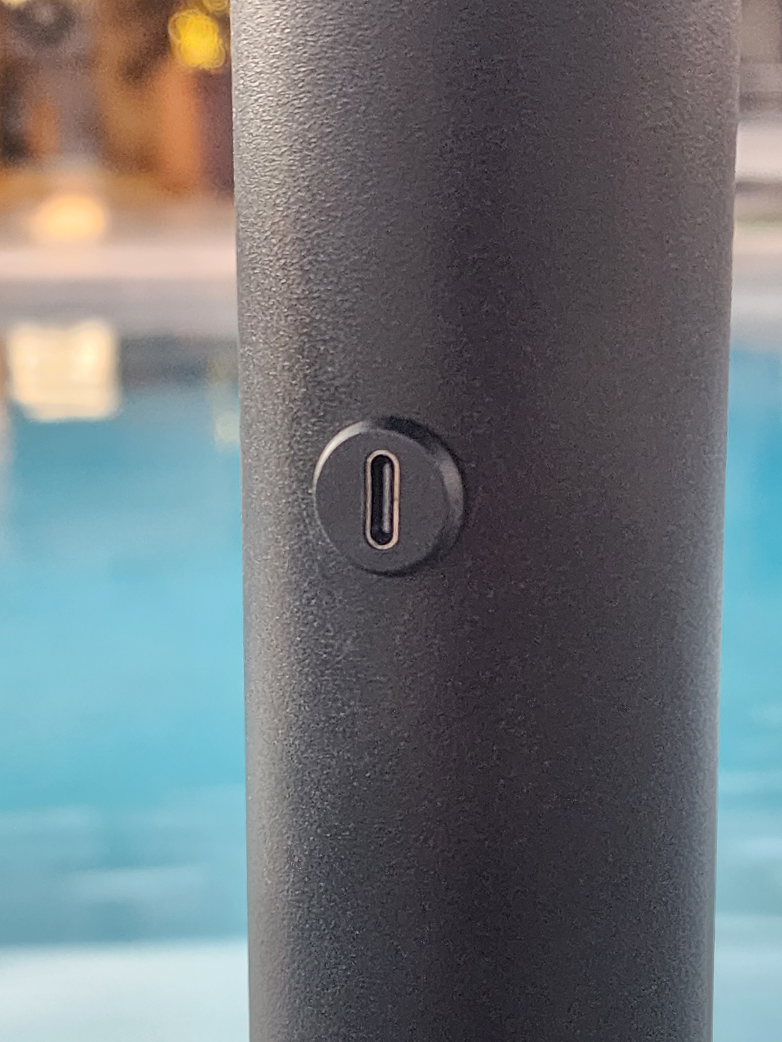 BajaMate patented in-pool umbrella tube with built-in USB-C solar charging phone port for Baja shelf and poolside charging. Caption