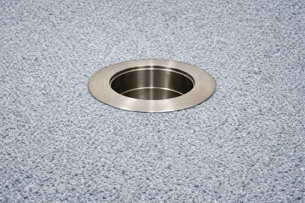 316 stainless steel in-pool umbrella sleeve with threadless cap installed in pool floor background.