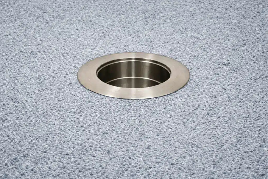 316 stainless steel in-pool umbrella sleeve with threadless cap installed in pool floor background.