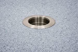 316 stainless steel in-pool umbrella sleeve with threadless cap installed in pool floor background.