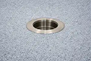 316 stainless steel in-pool umbrella sleeve with threadless cap installed in pool floor background.