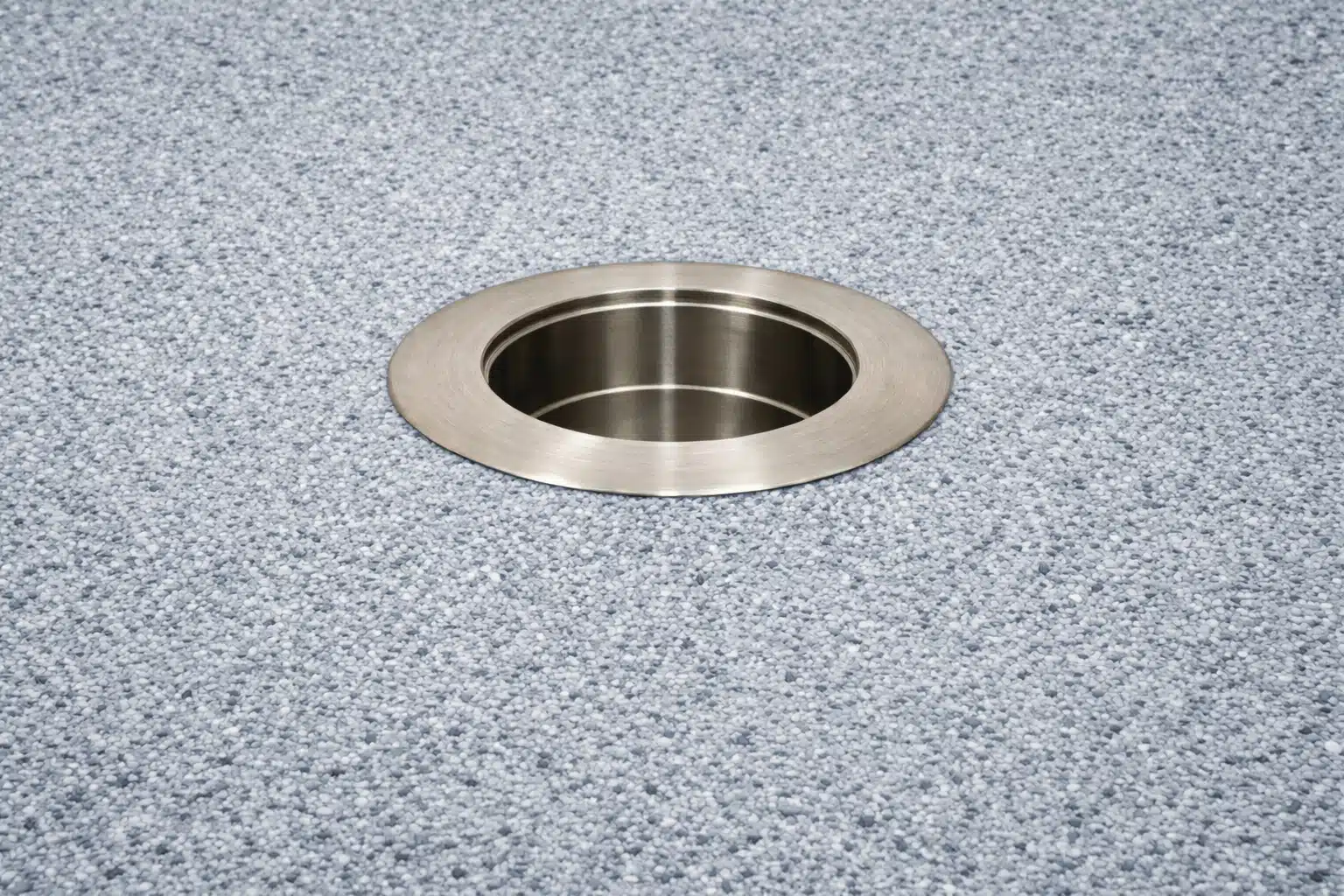 316 stainless steel in-pool umbrella sleeve with threadless cap installed in pool floor background.