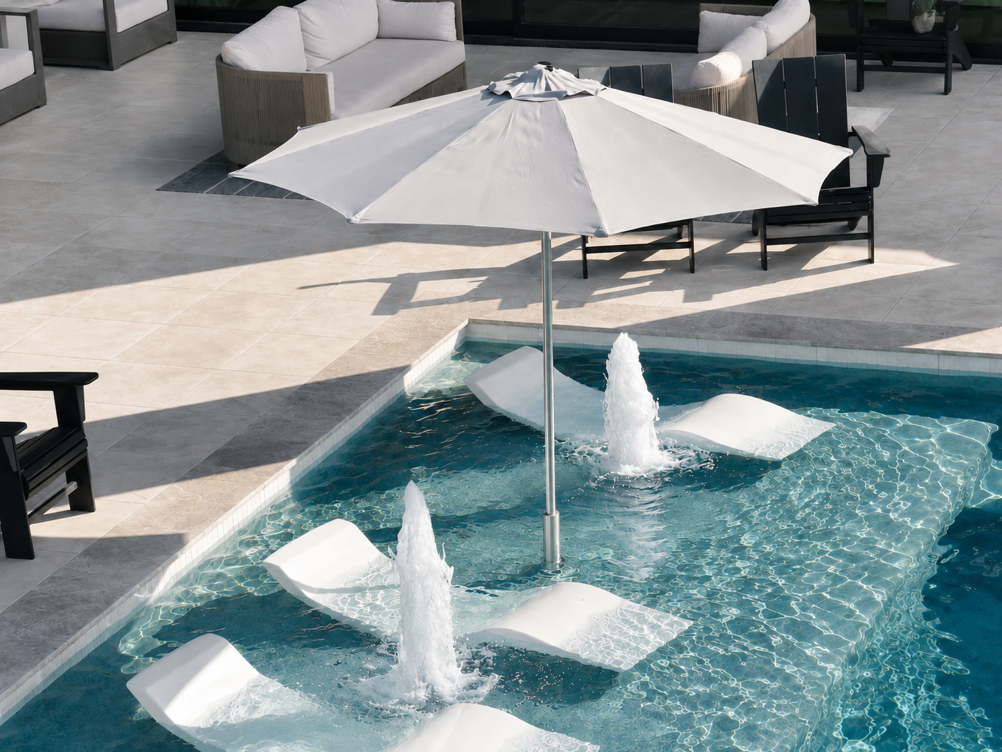 BajaMate Oasis 12-foot umbrella shade system installed on a baja shelf with in-pool loungers