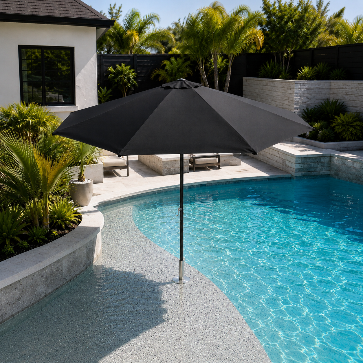 Black BajaMate oversized umbrella installed in a submerged pool sleeve on a curved Baja shelf.