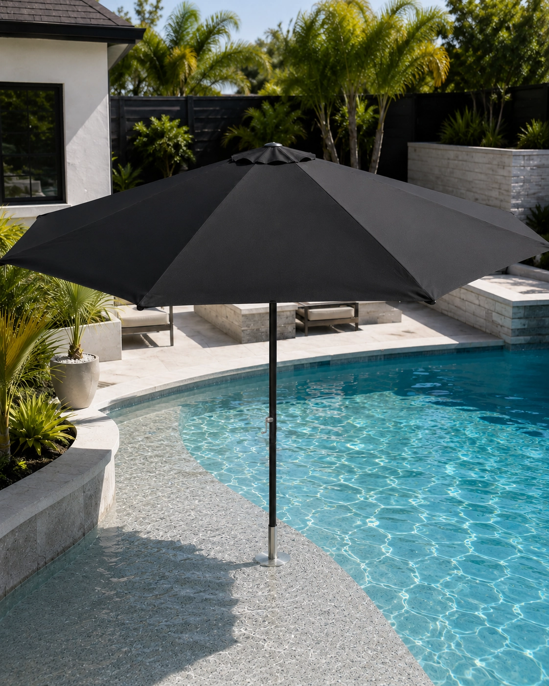 Black BajaMate pool umbrella installed in a stainless steel adapter on a shallow Baja shelf without a table.
