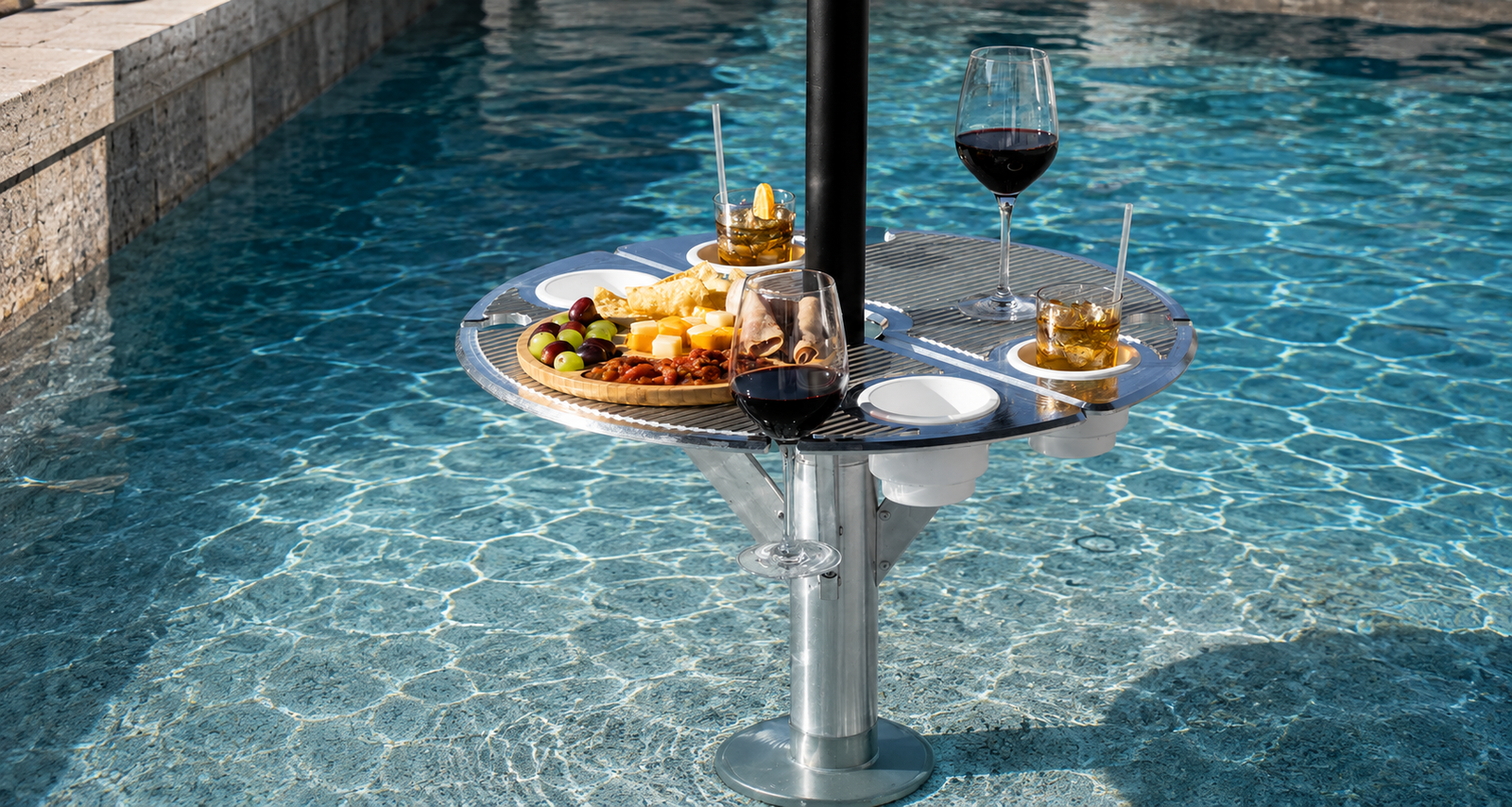BajaMate Gather Table installed in a swimming pool with wine, cocktails, snacks, and built-in cup holders