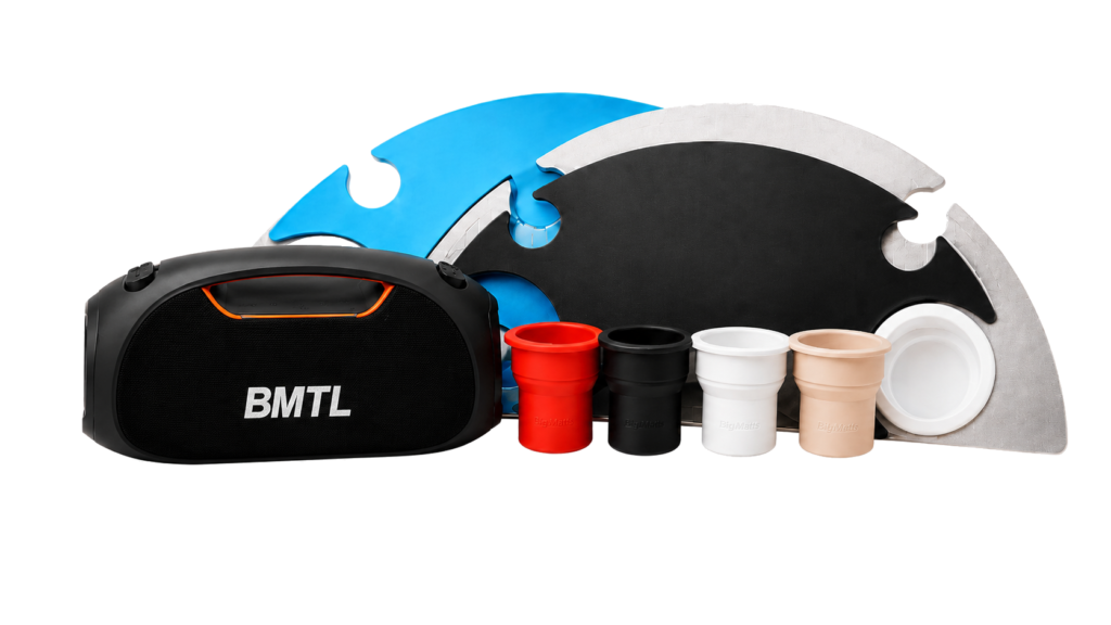 BajaMate poolside accessories including a Bluetooth speaker, silicone cup holders, and color-matched tabletop placemats.