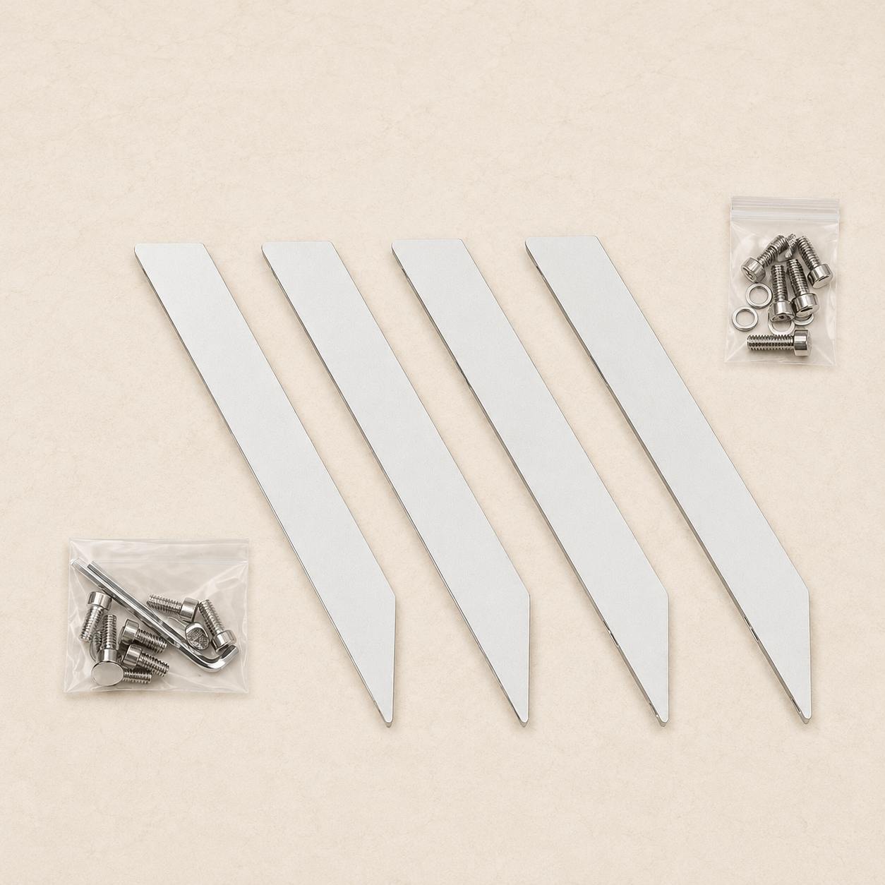 Four BajaMate aluminum table legs with replacement bolts, washers, and Allen keys on a light stone background.
