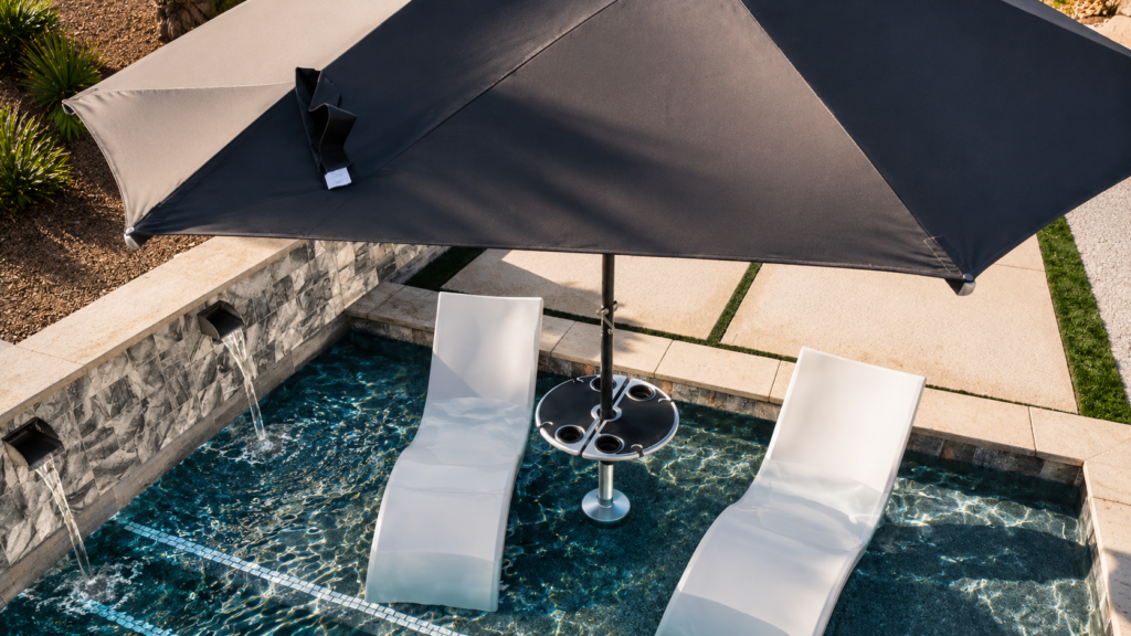 BajaMate in-pool umbrella and table installed between two white loungers on a luxury Baja shelf.